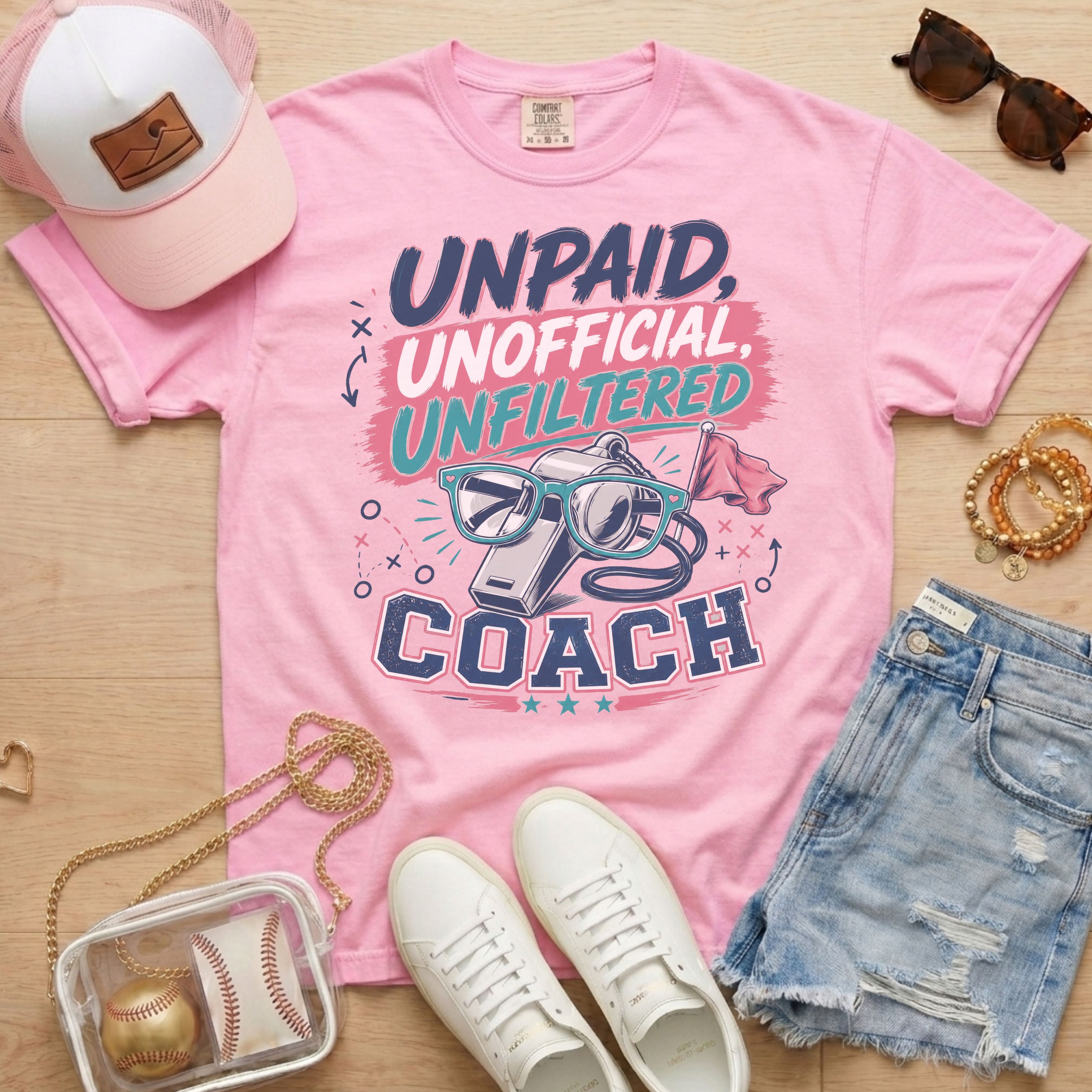 Unpaid Unofficial Unfiltered Coach Comfort Colors tee in blossom light pink flat lay with trucker hat, denim shorts, and white sneakers.