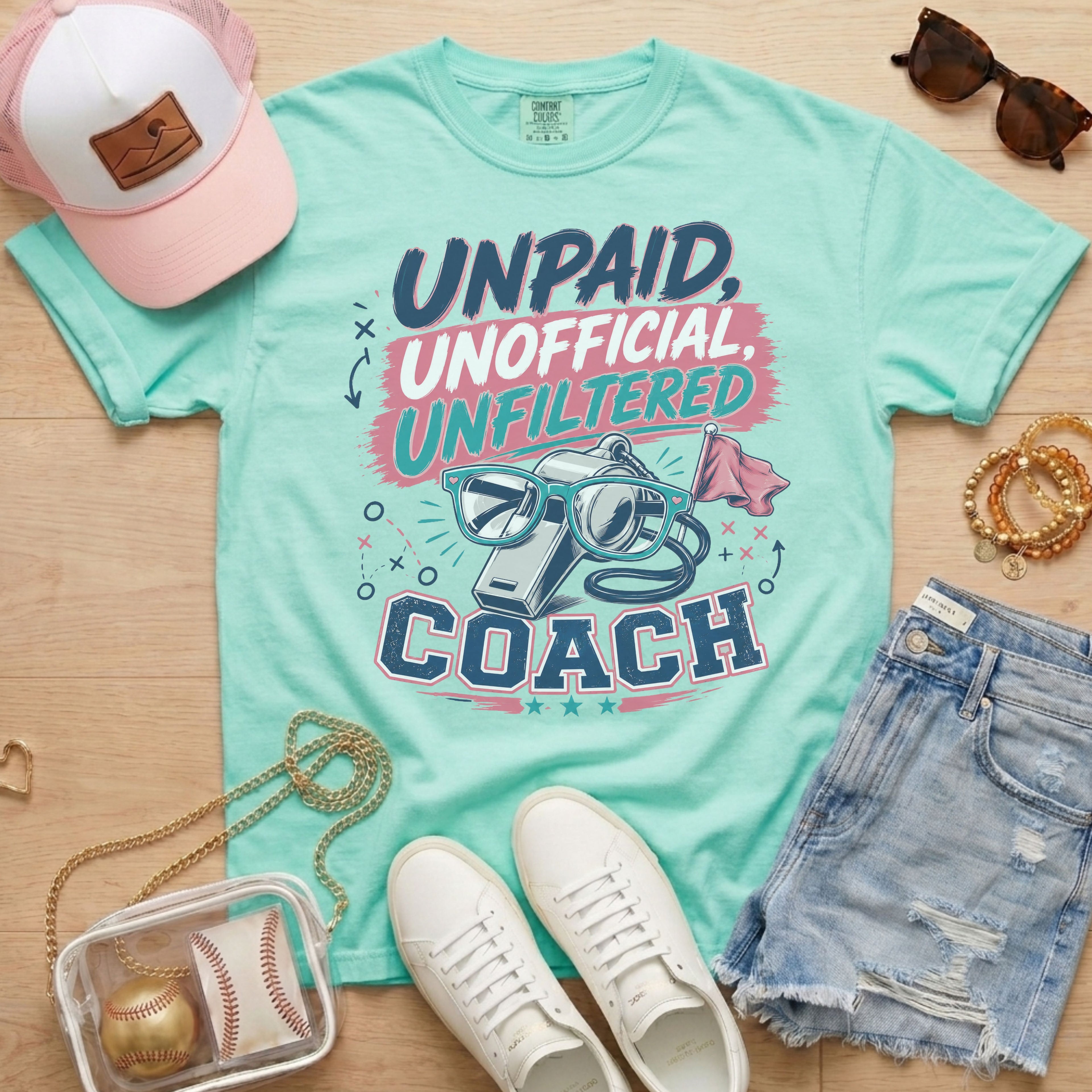 Unpaid Unofficial Unfiltered Coach Comfort Colors tee in light green flat lay with trucker hat, denim shorts, and white sneakers.