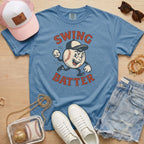 Blue jean colored Comfort Colors shirt with a retro swing batter baseball character