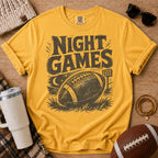 Golden yellow football graphic tee, Comfort Colors Mustard, styled with game day accessories and a distressed “Night Games” football design.