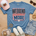 Weekend Tournament Mode Comfort Colors baseball mom tee in blue jean styled with denim shorts and game day accessories flat lay