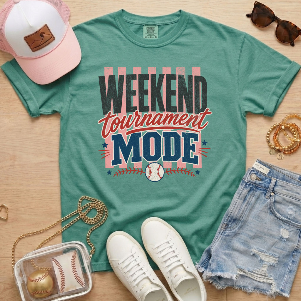 Weekend Tournament Mode Comfort Colors baseball mom tee in light green styled with denim shorts and game day accessories flat lay