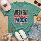 Weekend Tournament Mode Comfort Colors baseball mom tee in light green styled with denim shorts and game day accessories flat lay